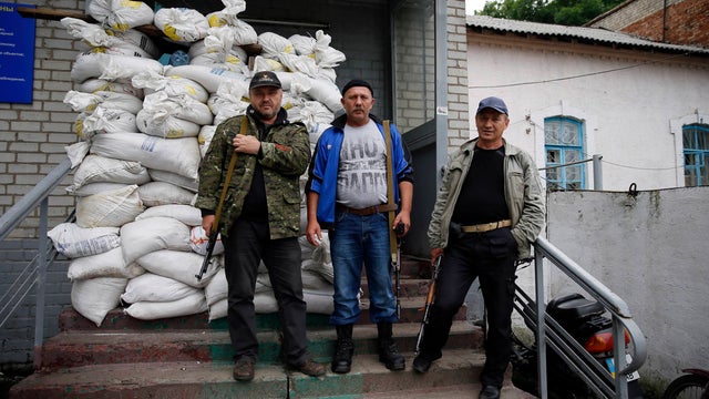 Separatists pose for a picture outside an office in the town of Druzhkovka, Donetsk region 