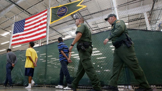 Detainees are escorted to an area to make phone calls as hundreds of mostly Central American immigrant children are processed and held at the U.S. Customs and Border Protection Nogales Placement Center 