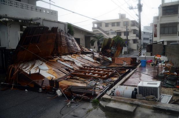 A wooden house collapsed during strong winds in Naha on Japan's southern island of Okinawa 