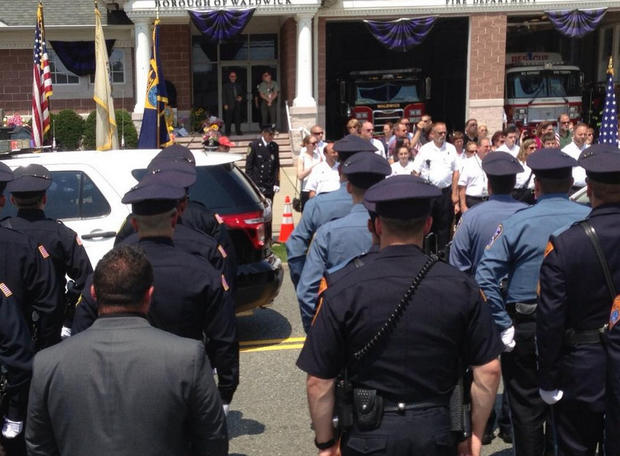 Police officers line street during procession for Waldwick Police Officer Christopher Goodell 