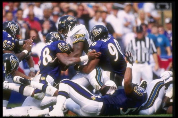 Peter Boulware #58 and Rob Burnett #90 stop the Jaguars Natrone Means  on Aug. 31st 1997  