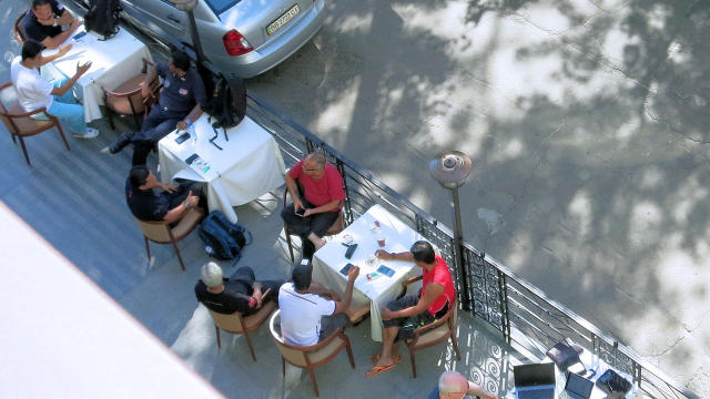 ​International inspectors sit outside at a hotel in Kharkiv, Ukraine, waiting for marching orders to try and reach the Malaysia Airlines Flight 17 crash site 