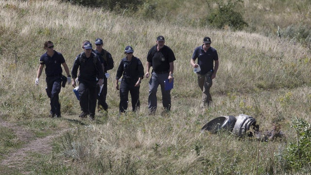 Australian experts examine the area of the Malaysia Airlines Flight 17 plane crash 