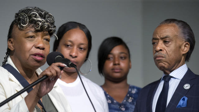 ​Gwen Carr, mother of Eric Garner, left, speaks alongside her daughter, Ellisha Garner, center left, and the Rev. Al Sharpton during a rally at the National Action Network headquarters July 26, 2014, in New York. 