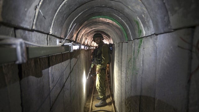 An Israeli army officer walks, July 25, 2014, during an army-organized tour in a tunnel said to be used by Palestinian militants from the Gaza Strip 