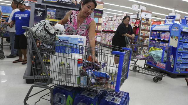 Shelly Nakasone looks through her shopping cart as she buys supplies as Hurricane Iselle and Tropical Storm Julio approached the Hawaiian islands, in Mililani, Hawaii, on August 5, 2014, though Iselle was expected to weaken to tropical storm strength 