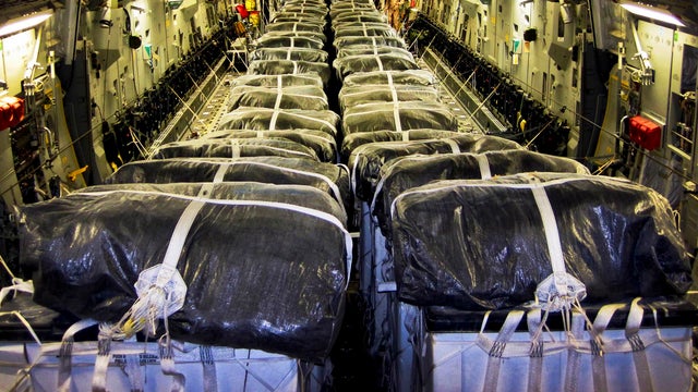 Water bundles align in a C-17 Globemaster III cargo plane at Al Udeid Air Base, Qatar, prior to a humanitarian airdrop over Iraq Aug. 8, 2014. 