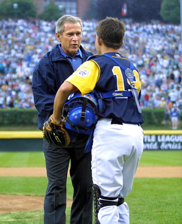 US President George W. Bush receives the baseball 