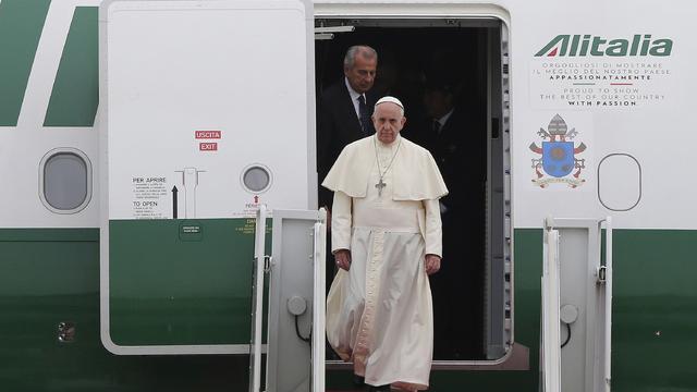 Pope Francis leaves his plane upon arrival at Seoul Air Base 