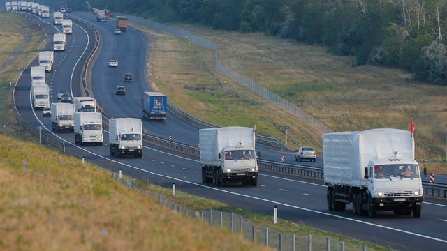A Russian convoy of trucks carrying humanitarian aid for Ukraine travels along a road south of the city of Voronezh 