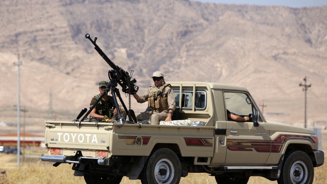 Iraqi Kurdish Peshmerga fighters drive toward the Mosul dam 