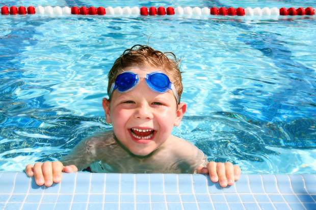 Happy kid child in a swimming pool 