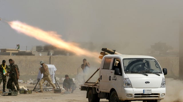 Iraqi security forces and Shiite militiamen fire at Islamic State of Iraq and Syria positions during an operation outside Amirli, some 105 miles north of Baghdad, Iraq, Sept. 3, 2014. 