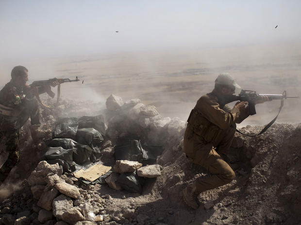 Iraqi Kurdish Peshmerga fighters fire at ISIS militant positions, from their position on the top of Mount Zardak, a strategic point taken 3 days before, about 15 miles east of Mosul on September 9, 2014 