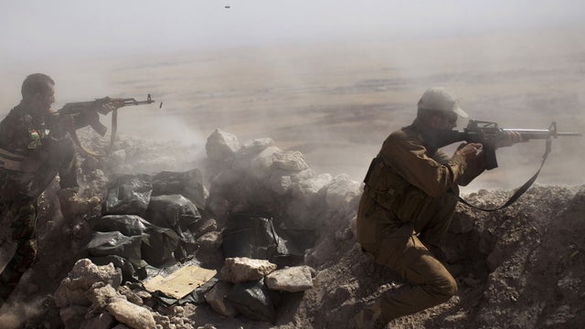 Iraqi Kurdish Peshmerga fighters fire at ISIS militant positions, from their position on the top of Mount Zardak, a strategic point taken 3 days before, about 15 miles east of Mosul on September 9, 2014 