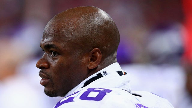 Adrian Peterson looks on from the sideline during a Minnesota Vikings game against the St. Louis Rams on Sept. 7, 2014 