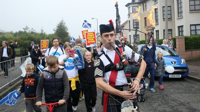 A man plays the bagpipes on a "short walk to freedom" march in Edinburgh 