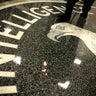 A man walks across the seal of the Central Intelligence Agency at the lobby of the Original Headquarters Building at the CIA headquarters Feb. 19, 2009, in McLean, Virginia. 