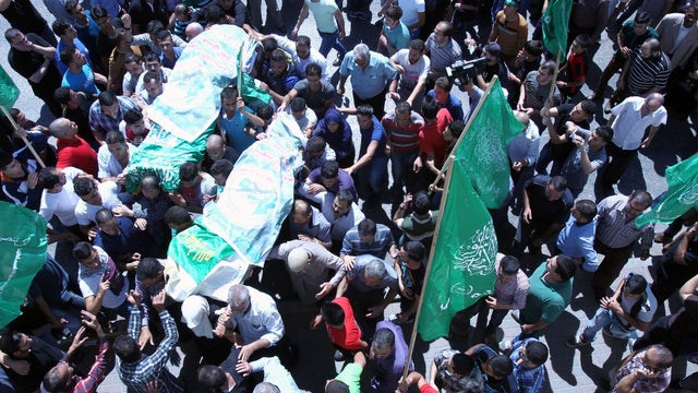 Mourners carry the bodies of Amer Abu Eisha and Marwan Qawasmeh during their funeral in the West Bank town of Hebron 