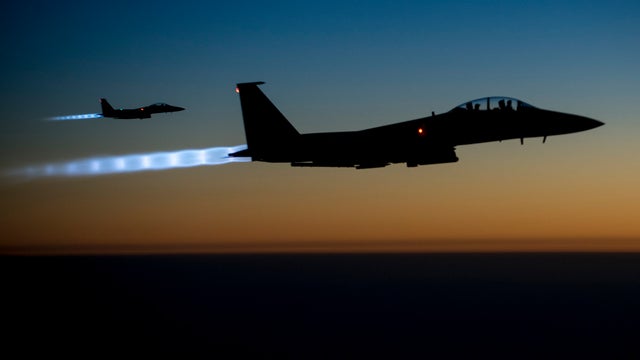 A pair of U.S. Air Force F-15E Strike Eagles fly over northern Iraq after conducting airstrikes in Syria 