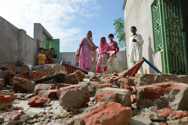Civilians gaze at remains of home destroyed by India-Pakistan border dispute 