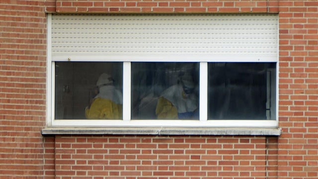 Medical staff wearing protective suits work in a quarantine area on the sixth floor at the Carlos III hospital in Madrid 