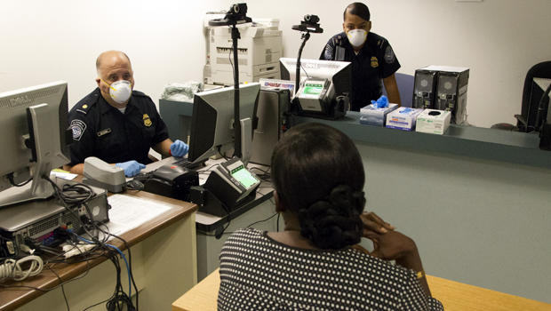 U.S. Customs and Border Protection officers conduct enhanced screening for the Ebola virus at Kennedy International Airport in New York Oct. 11, 2014. 