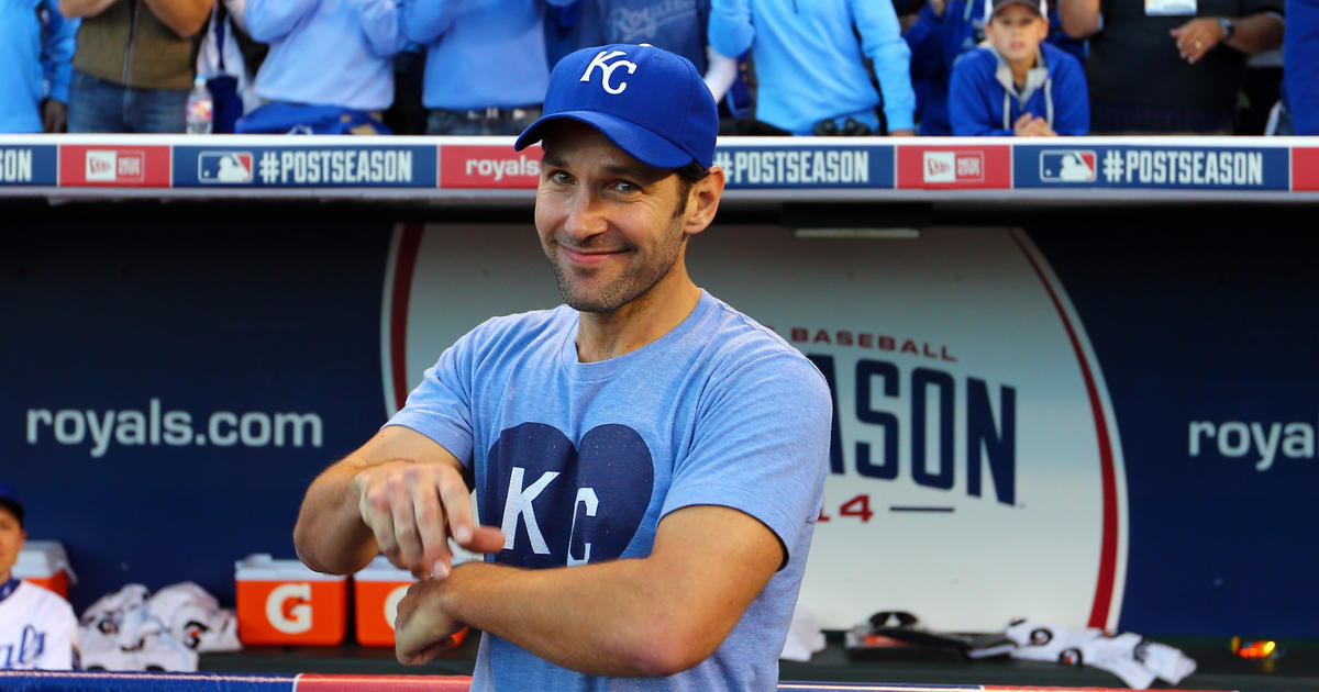 Comedian Paul Rudd, left, put on a Kansas City Royals shirt and