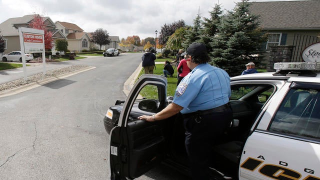 Police keep watch on a home, Oct. 16, 2014, in Tallmadge, Ohio, where Amber Joy Vinson stayed 