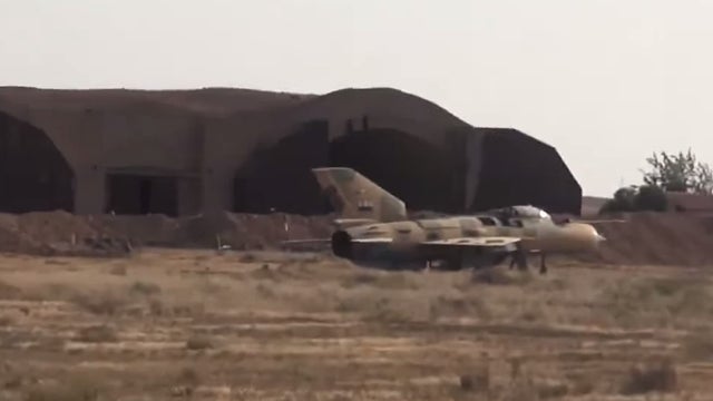 ​An image from an ISIS propaganda video posted online Sept. 9, 2014 shows a fighter jet on the ground near the Syrian al-Tabqa air base, which the militants captured 