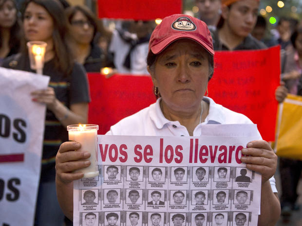 People take part in a march demanding justice for the 43 missing students along a street in Mexico City 