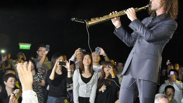 ​Kenny G performs as members of the public look on in Hong Kong 