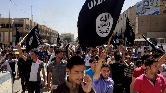 Demonstrators chant in support of the Islamic State of Iraq and Syria group in front of the provincial government headquarters in Mosul, Iraq, June 16, 2014. 