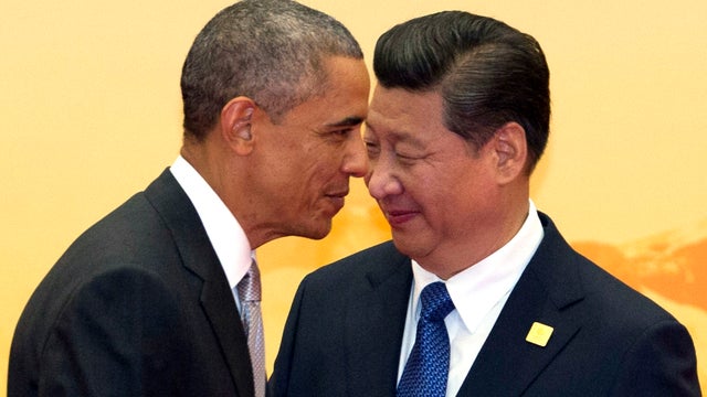  President Obama walks past Chinese President Xi Jinping during welcome ceremony of the APEC summit in Beijing on November 11, 2014 