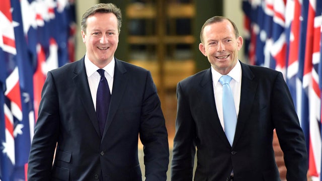 British Prime Minister David Cameron walks with Australian Prime Minister Tony Abbott 