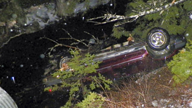 An SUV rests upside down in water alongside Route 6 in Kossuth Township, Maine, after Stephen McGouldrick lost control of it on the icy road Nov. 17, 2014, in this picture provided by the Maine State Police. 