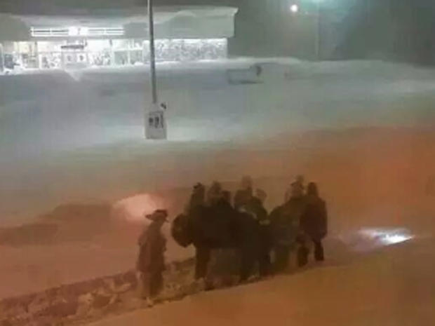 First responders carry a patient 10 blocks through fiercely heavy snow to a hospital in the Buffalo, New York, area Nov. 19, 2014. 
