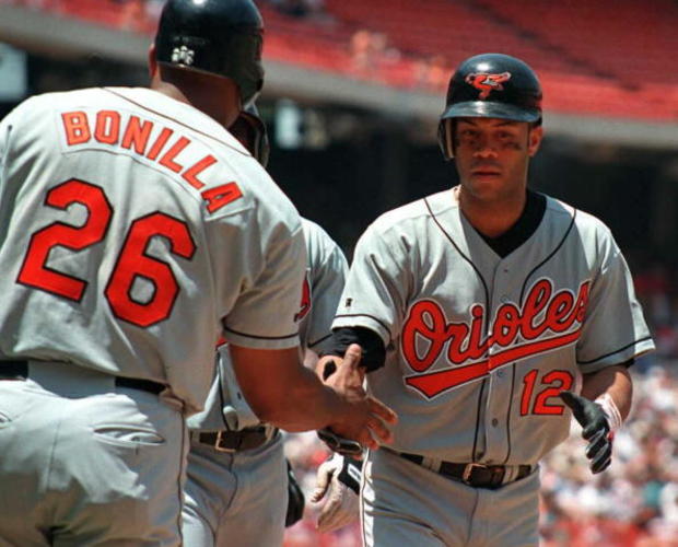 Roberto Alomar of the Baltimore Orioles (R) is gre 