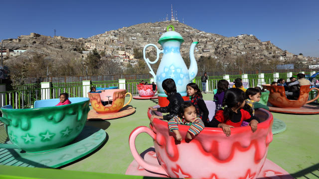 Children enjoy a spinning teacup ride at Afghanistan's first amusement park called City Park in Kabul.  