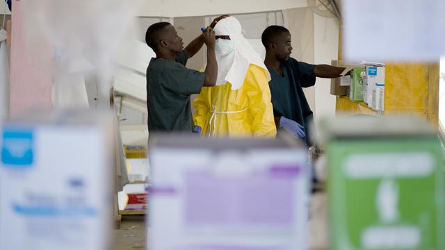 A worker wearing Personal Protective Equipment (PPE) has his name written on his suit before leaving the red zone at the Ebola treatment center run by the French red cross society in Macenta in Guinea 