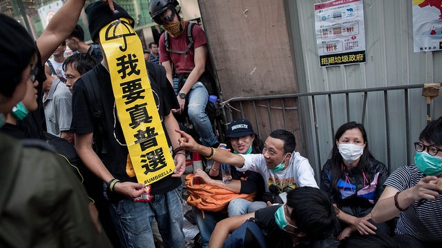 HONG KONG - NOVEMBER 25: Pro-democracy protesters hold banners and shout slogans on Argyle Street in Mongkok district on November 25, 2014 in Hong Kong. 