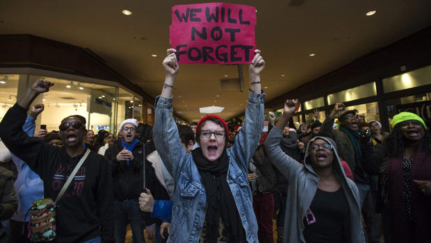 Protesters, demanding justice for the killing of 18-year-old Michael Brown, shout slogans while marching through the St. Louis Galleria Mall in Missouri Nov. 28, 2014. 