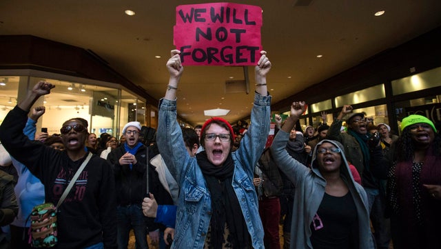 Protesters, demanding justice for the killing of 18-year-old Michael Brown, shout slogans while marching through the St. Louis Galleria Mall in Missouri Nov. 28, 2014.