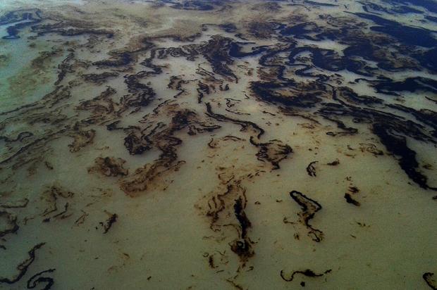 Oil from sunken tanker is seen on the Shela River in the Sundarbans mangrove forest in Bangladesh, Dec. 9, 2014. 