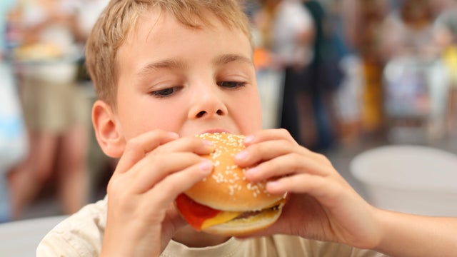 boy eating hamburger 