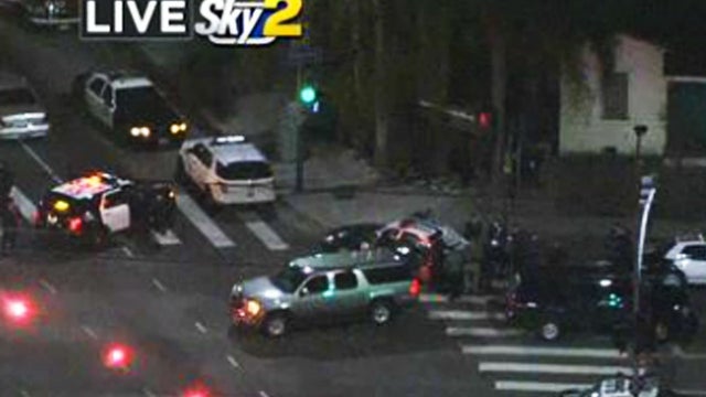 Los Angeles police converge on an area where shots were fired at a patrol car Dec. 28, 2014. 