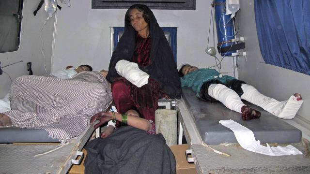 Injured Afghan civilians are brought to a hospital by ambulance in Helmand province 