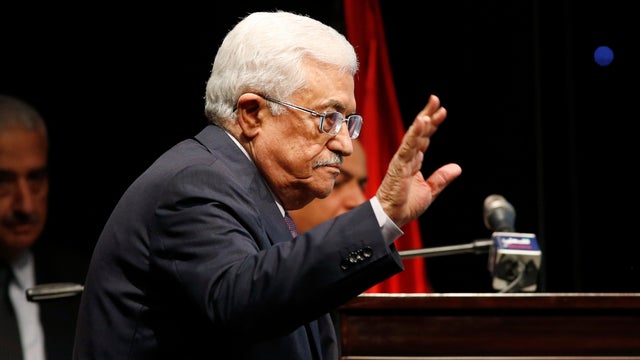Palestinian President Mahmoud Abbas waves during the opening ceremony of "Jerusalem in Memory" exhibition in the West Bank city of Ramallah 