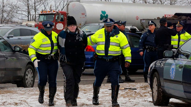 Police detain a protester who was part of a group who blocked southbound lanes of Interstate 93 during the morning rush hour in Somerville, Massachusetts, Jan. 15, 2015. 