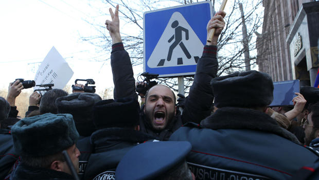 Policemen block protesters near the Russian Embassy in Yerevan, Armenia, Jan. 15, 2015. 
